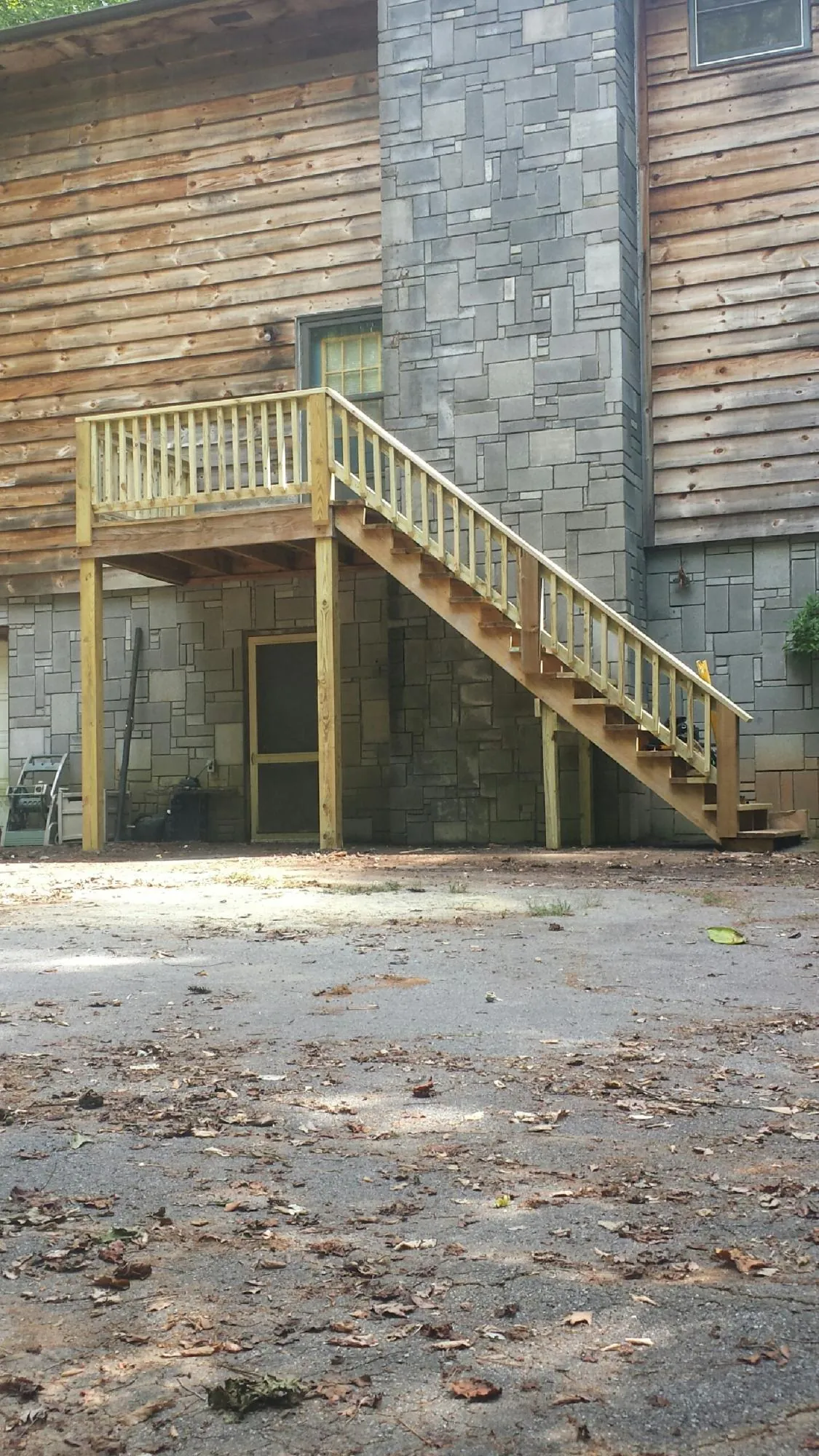New pressure treated deck and stair landing on a log home in Purcellville