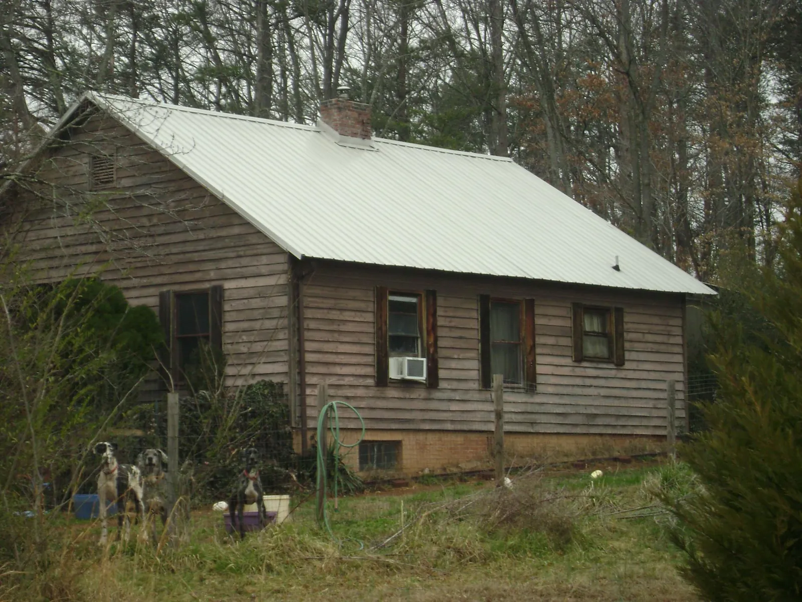 White metal roof on an old wood sided farmhouse, from a Metal Roof Installation job in Purcellville